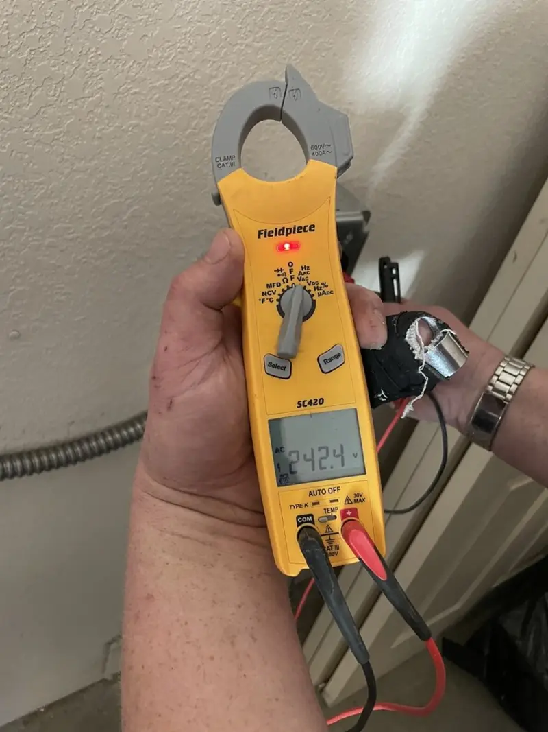 Voltage testing with clamp meter during Recessed Lighting Installation in Alsace